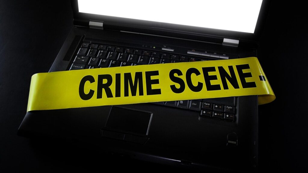 crime scene tape on a computer keyboard - Philadelphia computer crimes defense lawyers