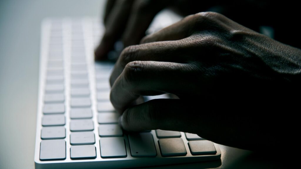 close-up of hands typing on a keyboard