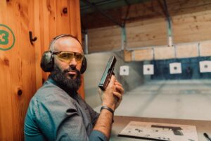 Man at a New Jersey shooting range practicing with a firearm – legal gun ownership vs. weapons charges